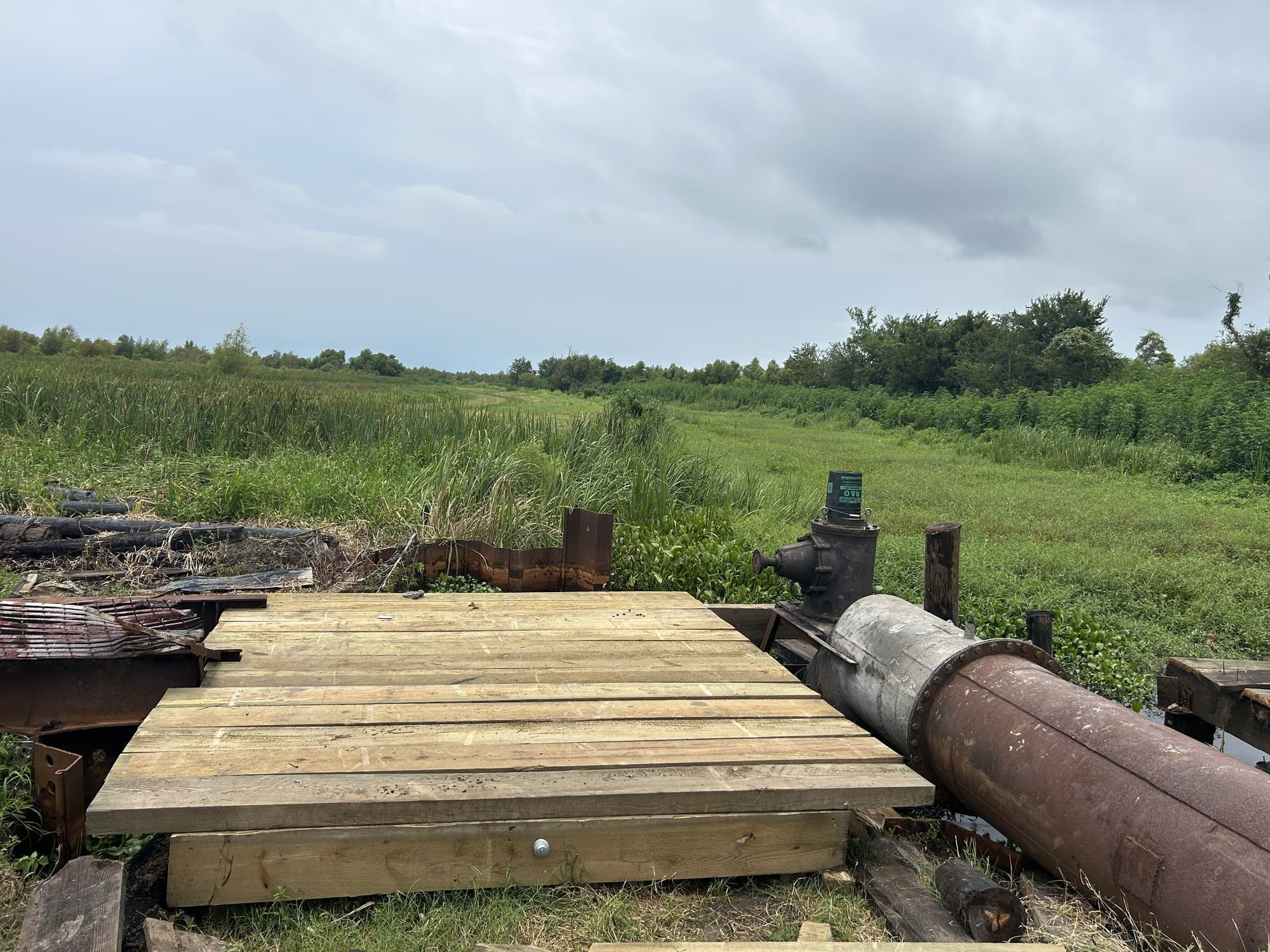Timber mat platform staged for marsh construction work