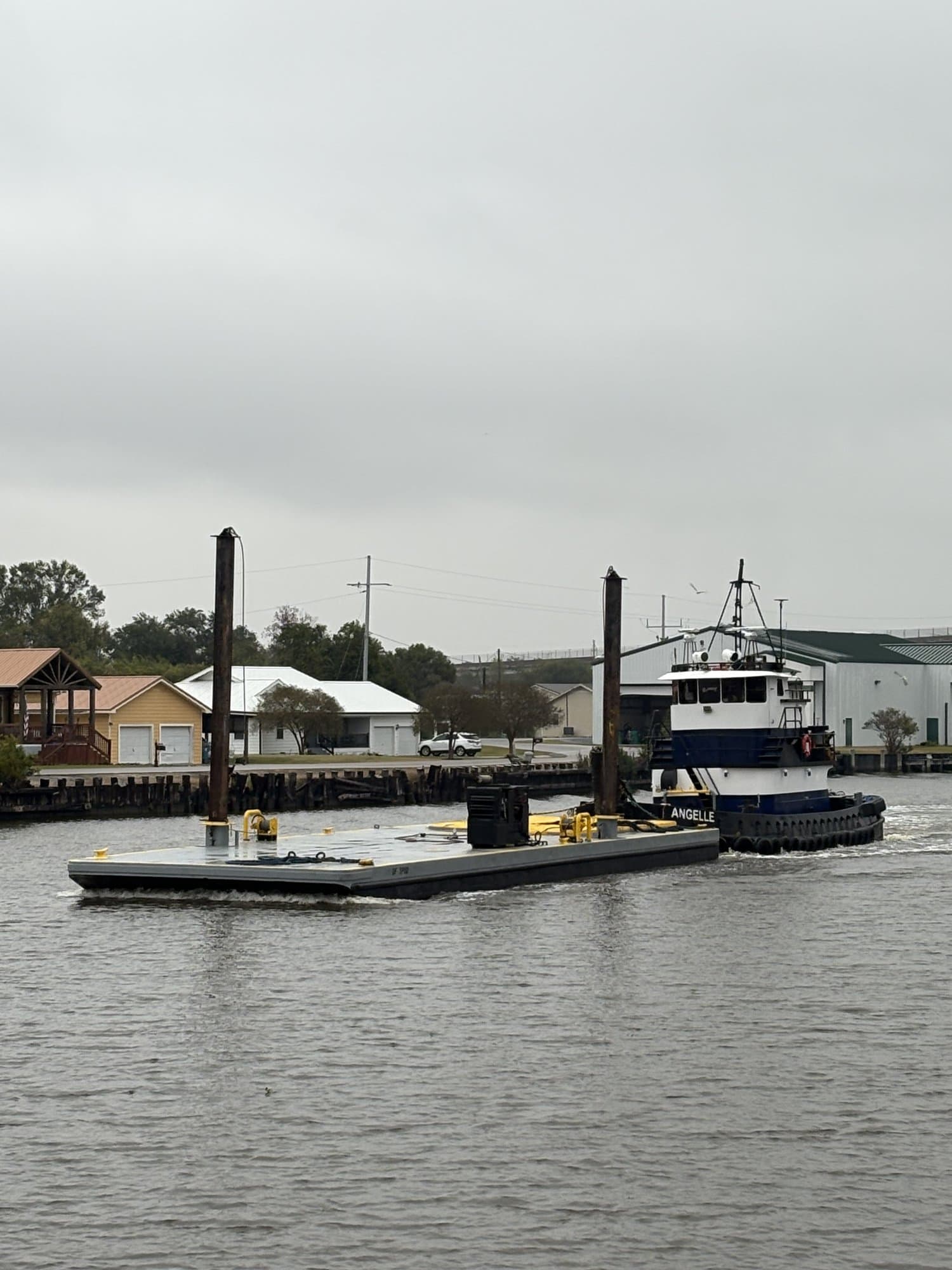 Melancon Marine tugboat pushing a spud barge on a Louisiana waterway